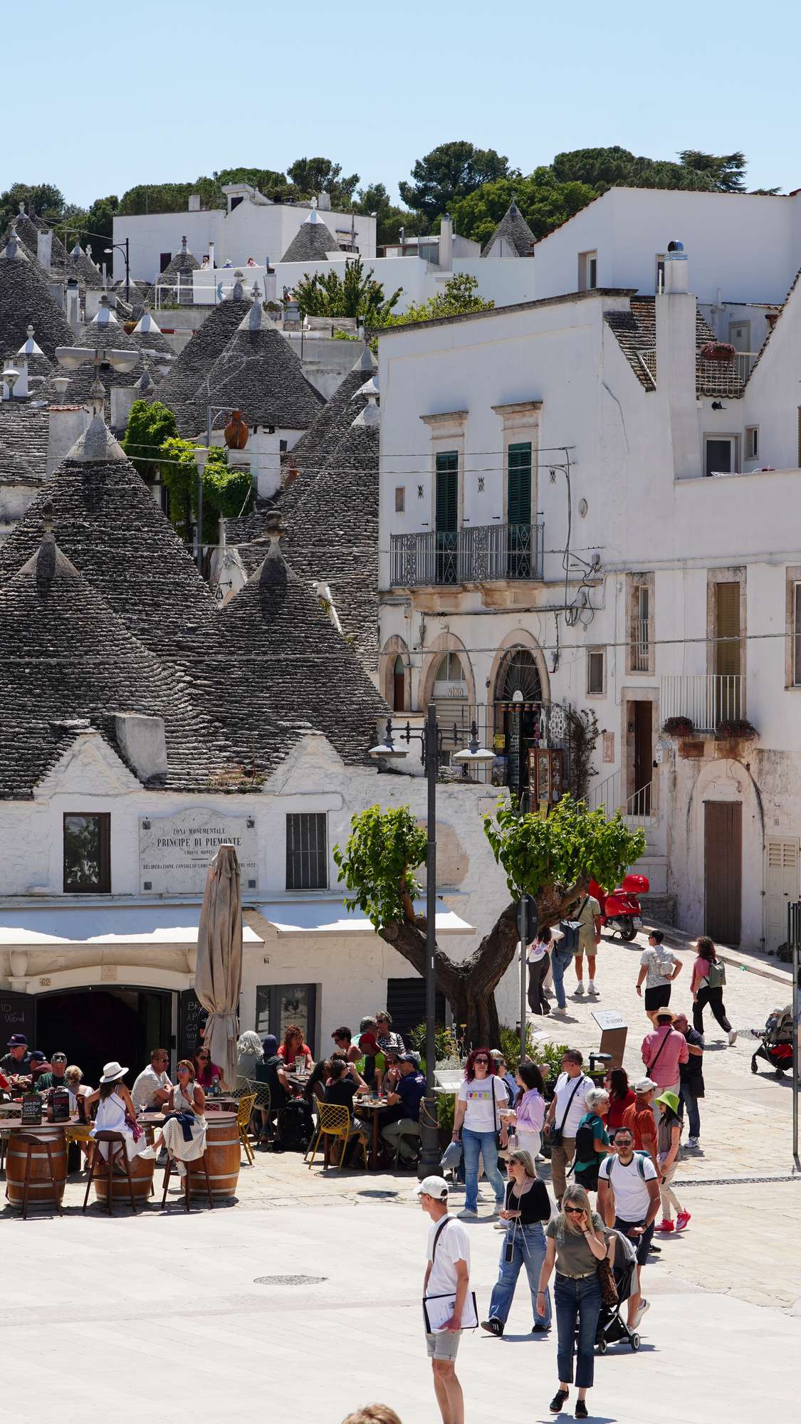 Visitors walking through Alberobello