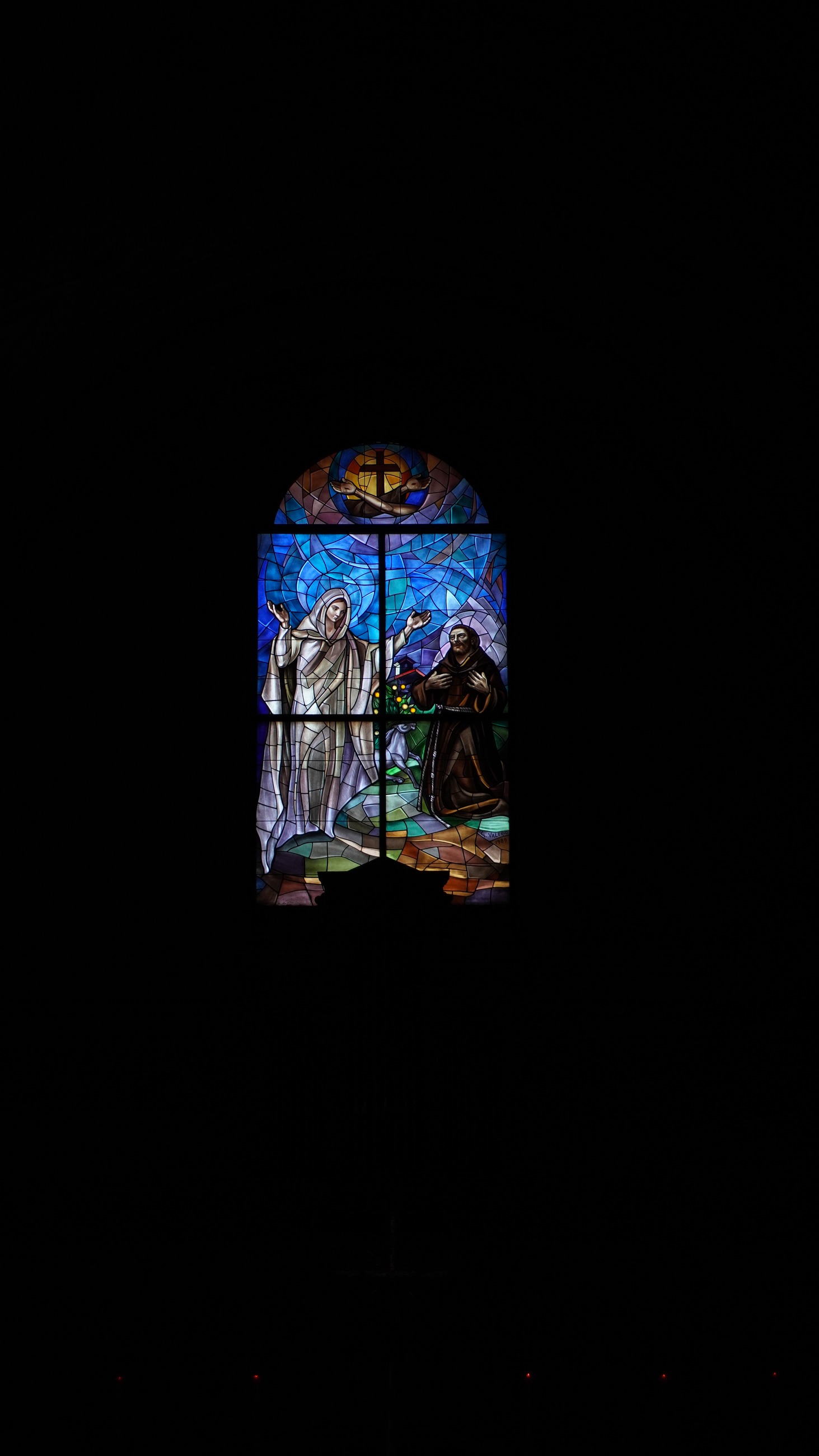 Stained glass glowing in darkness
